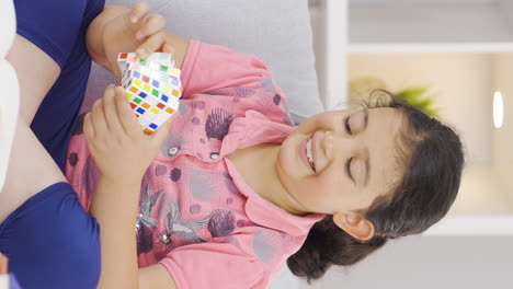 Vertical-video-of-Girl-child-playing-with-a-intelligence-cube.
